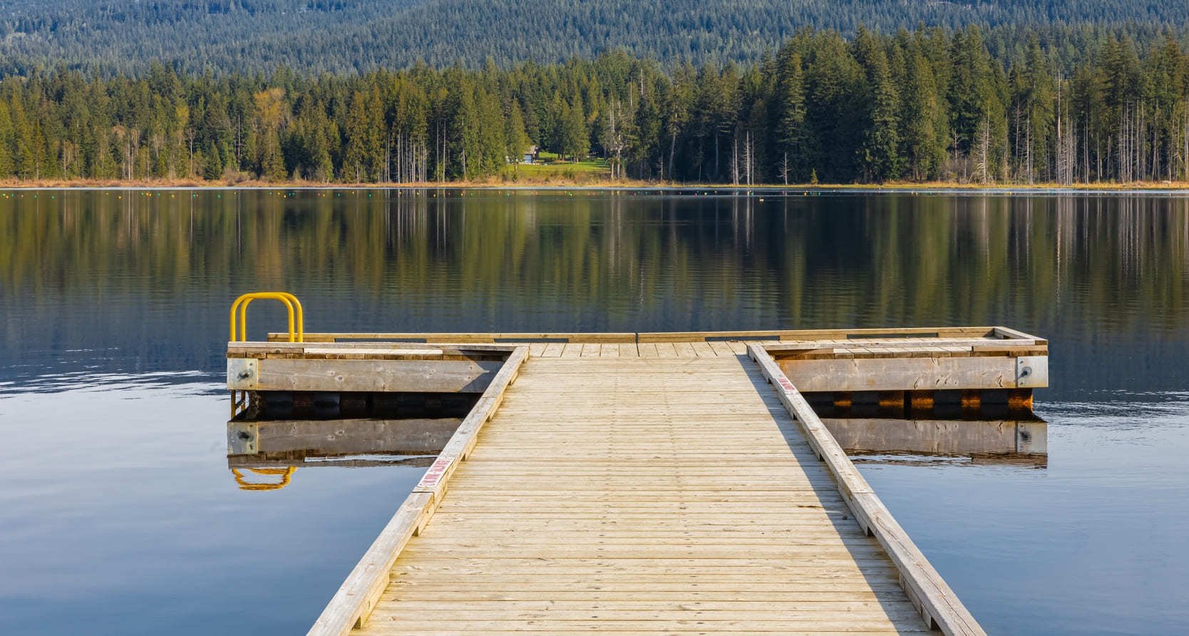 Wooden pier on a beautiful, peaceful lake in British Columbia